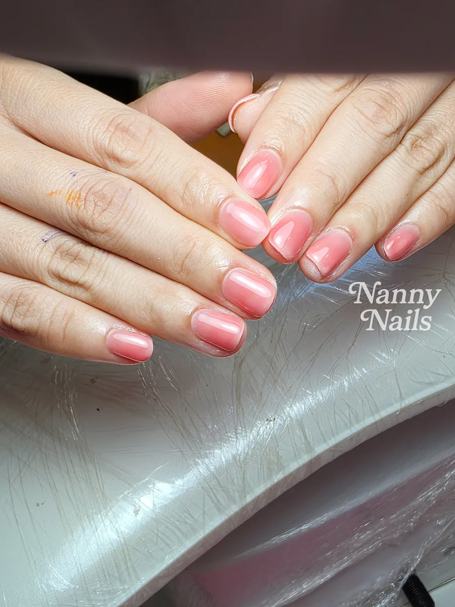 Short nails in a sheer pink gel colour, healthy-looking nails, Nanny Nails, nail salon in Nakhon Phanom