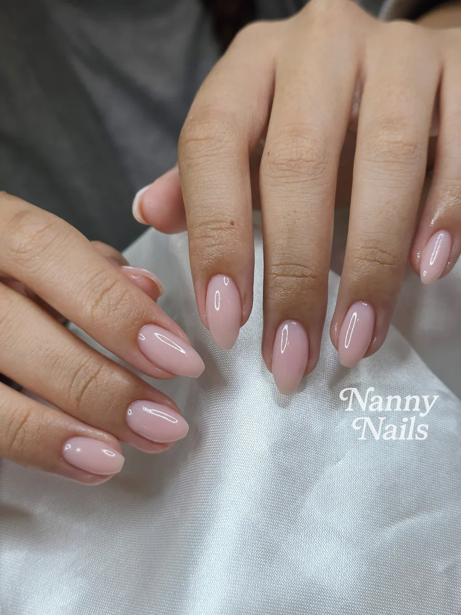 Nude pink gel nails in an almond shape, smooth and glossy all over, Nanny Nails, nail salon in Nakhon Phanom