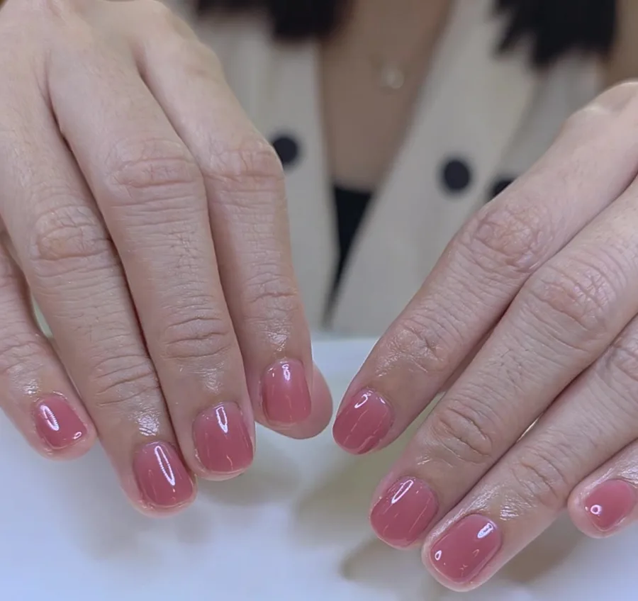 Short nails in a sheer rose nude jelly gel polish with a glossy finish, Nanny Nails Nakhon Phanom
