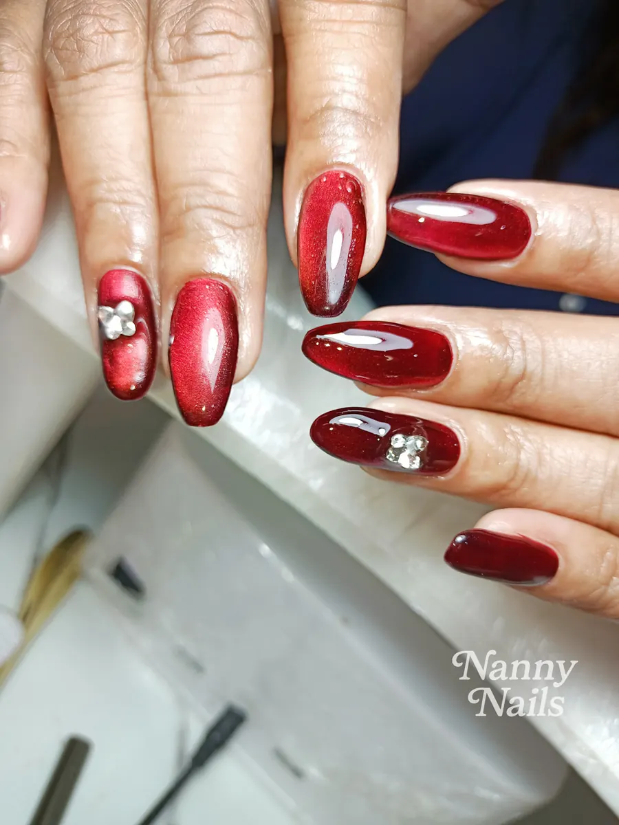 Red cat eye nails with rhinestones, Nanny Nails, nail salon in Nakhon Phanom