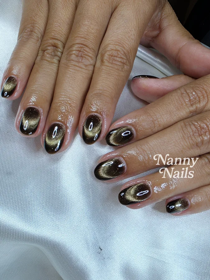 Black cat eye nails with a gold flash, Nanny Nails, nail salon in Nakhon Phanom