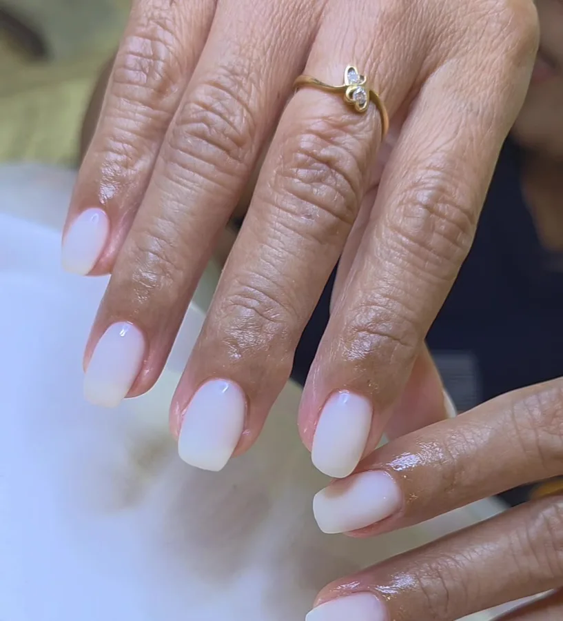 Milky white gel nails with a matte finish, showing what matte looks like, on a female customer, Nanny Nails Nakhon Phanom