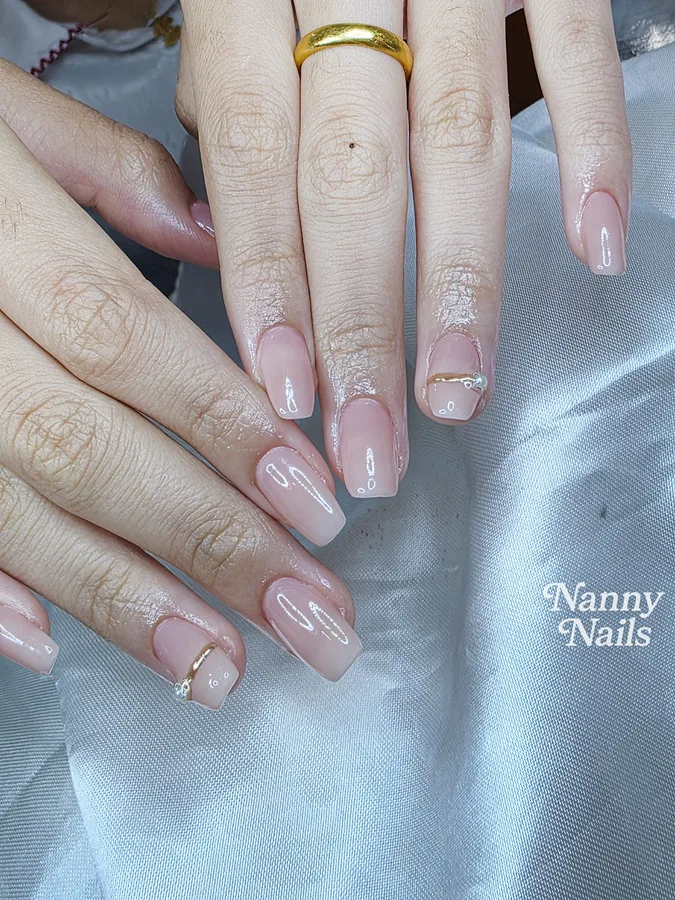 Natural-looking pale nude pink gel nails with small gold accents, Nanny Nails Nakhon Phanom
