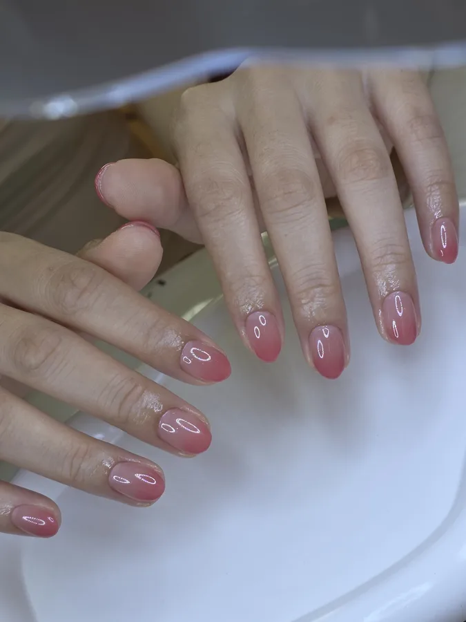 Pink ombre gel nails with a clear base fading to pink at the tip, so the grown-out base blends in, Nanny Nails Nakhon Phanom