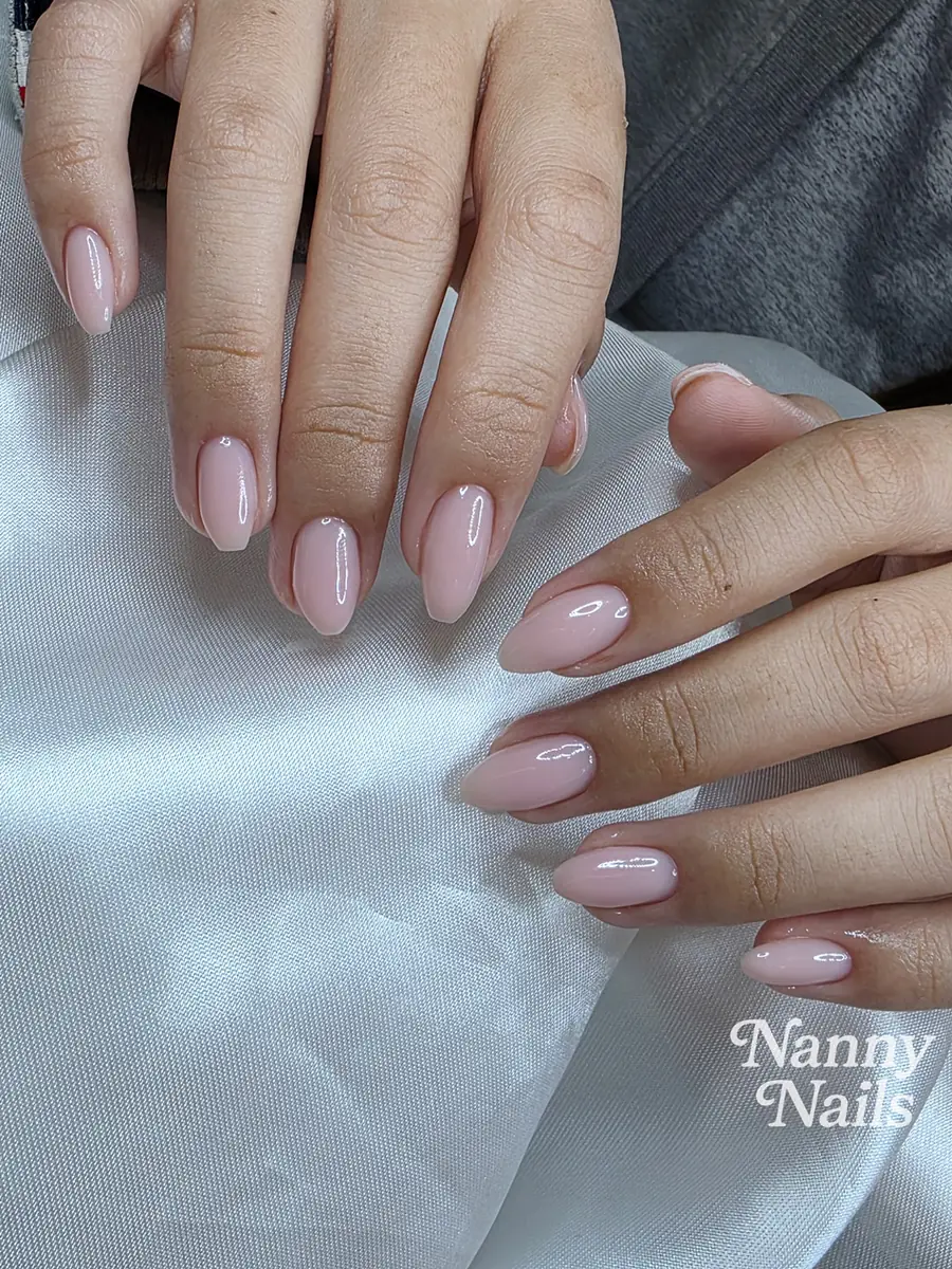 Nude pink gel nails with a smooth glossy surface, almond shape, Nanny Nails Nakhon Phanom