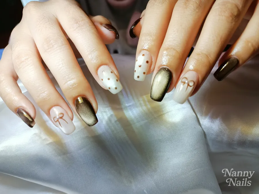 Mix and match nails with caramel cat eye, polka dots and a bow, Nanny Nails, nail salon in Nakhon Phanom