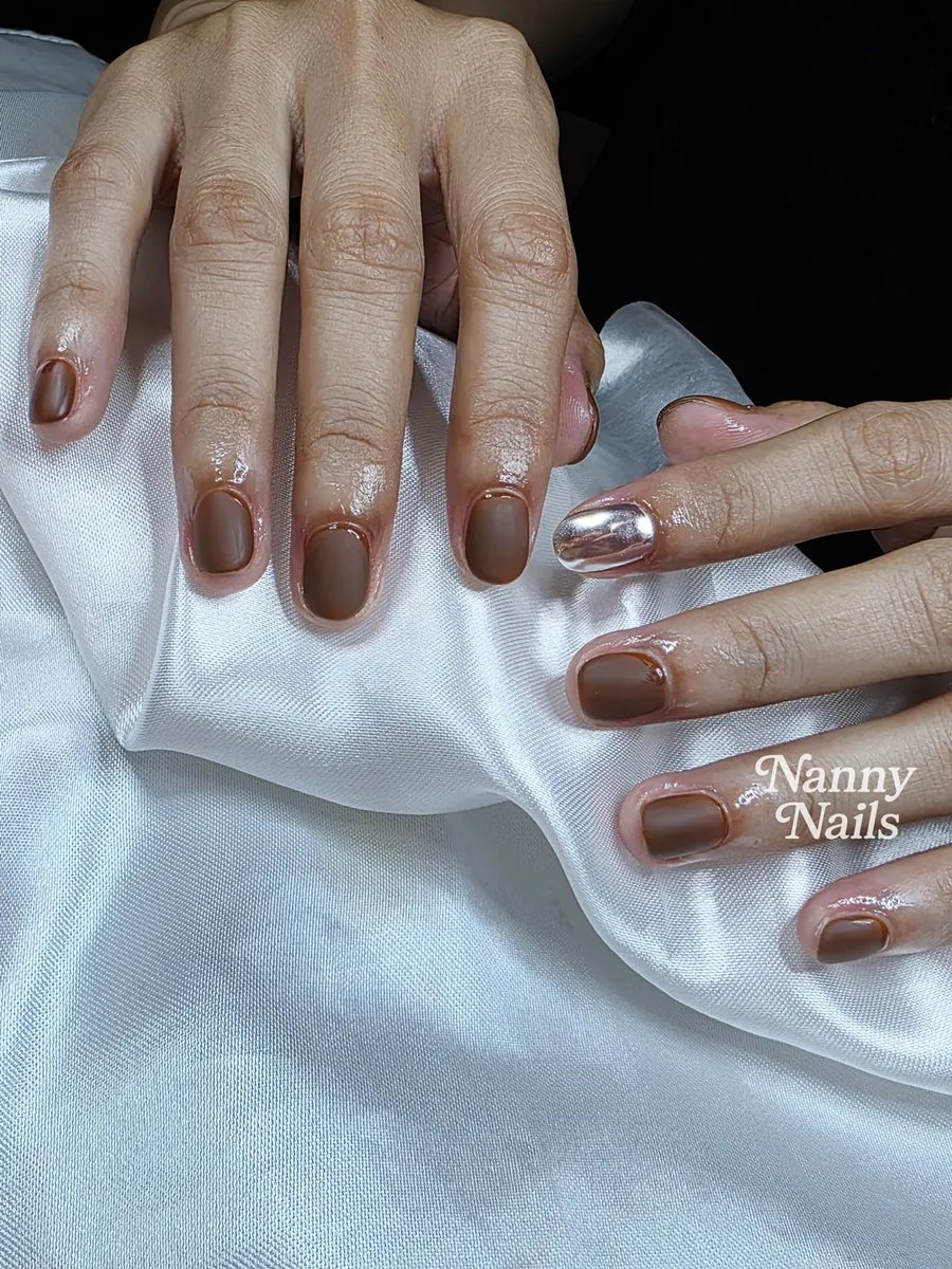 Chocolate brown gel on short nails with one chrome accent finger, Nanny Nails, nail salon in Nakhon Phanom