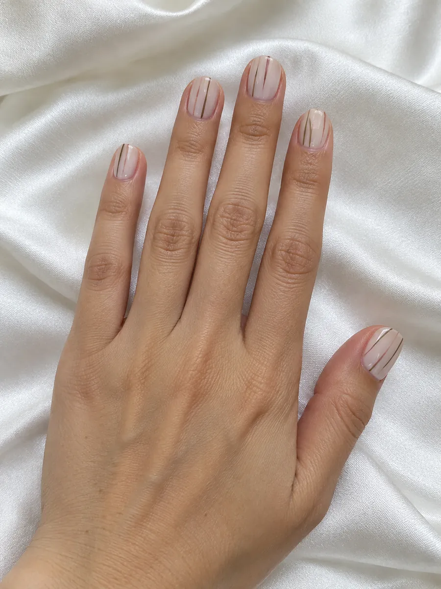 Nail design idea for 2027: fine stripes in muted colours on a milky base, AI image, not salon work, Nanny Nails, Nakhon Phanom