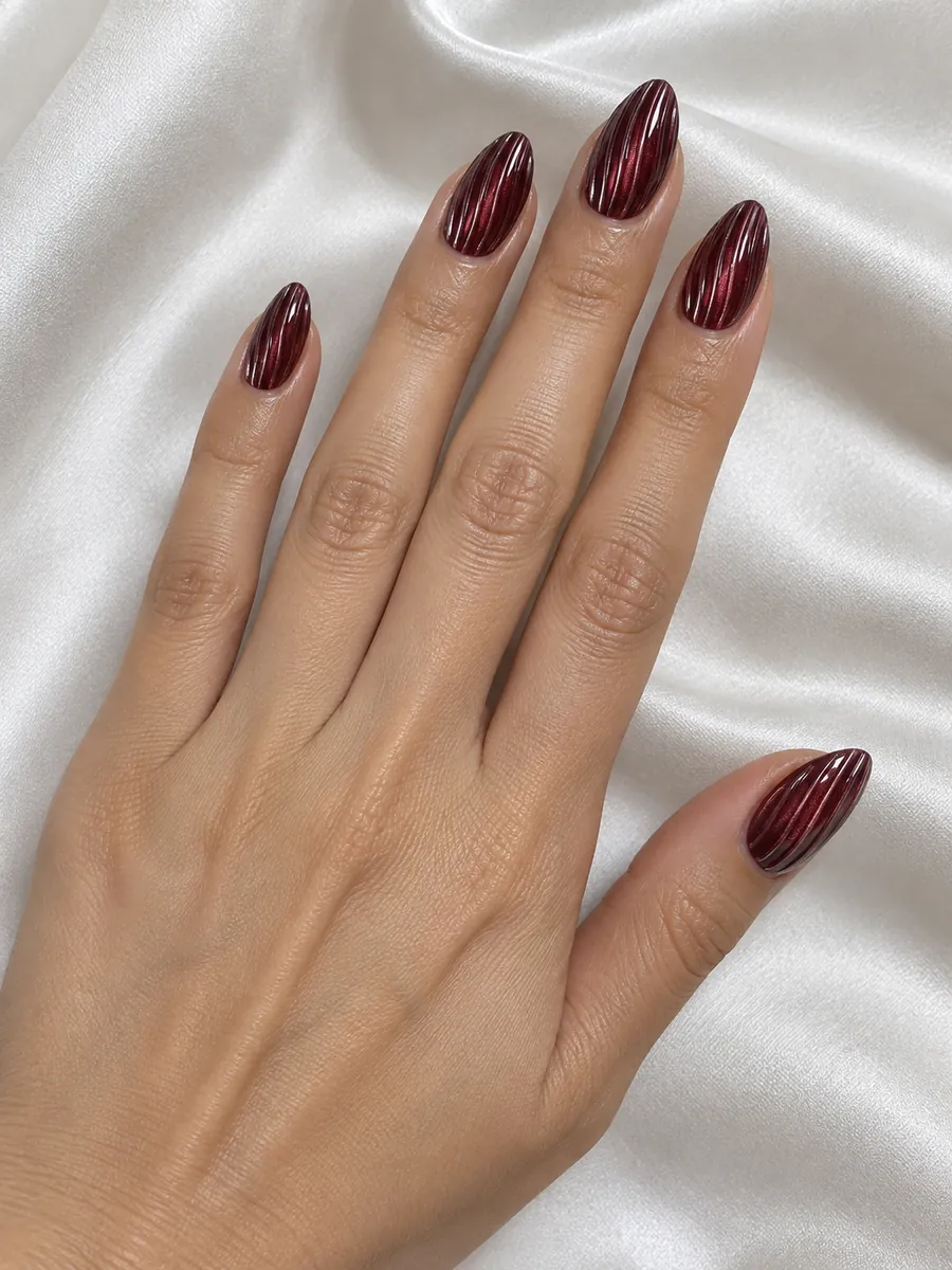 Nail design idea for 2027: clear ribbed gel like cut crystal over burgundy cat eye, AI image, not salon work, Nanny Nails, Nakhon Phanom
