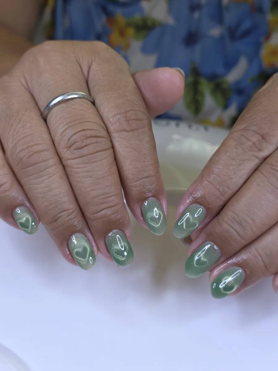 Sage green cat eye gel nails with a heart design, Nanny Nails, nail salon in Nakhon Phanom