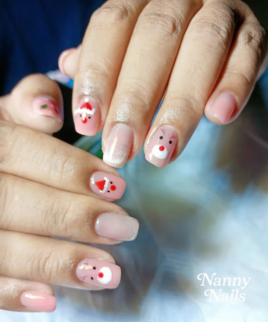 Cute Christmas nails, Santa and reindeer on a pinky nude base, Nanny Nails, nail salon in Nakhon Phanom