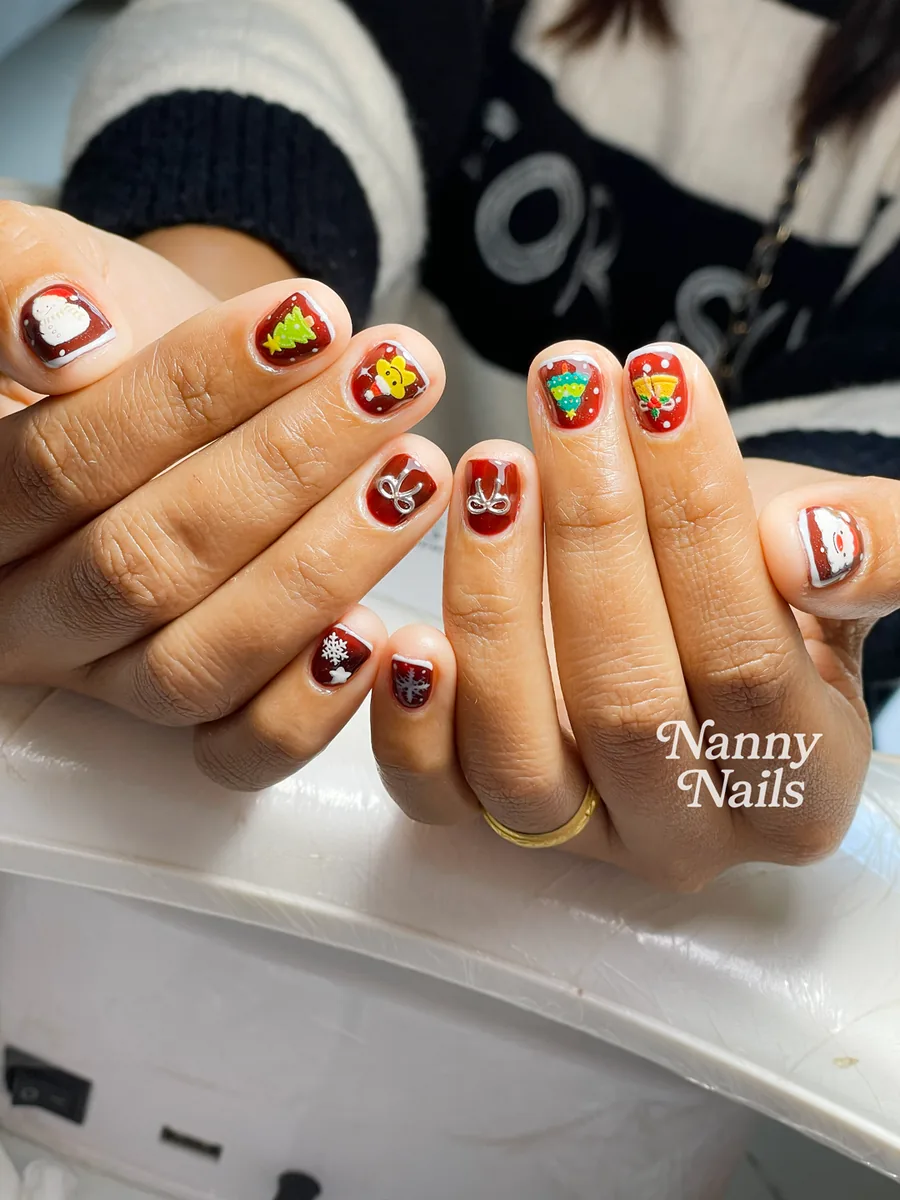 Cute Christmas nails on short deep red nails with a Christmas tree and snowman, Nanny Nails, nail salon in Nakhon Phanom
