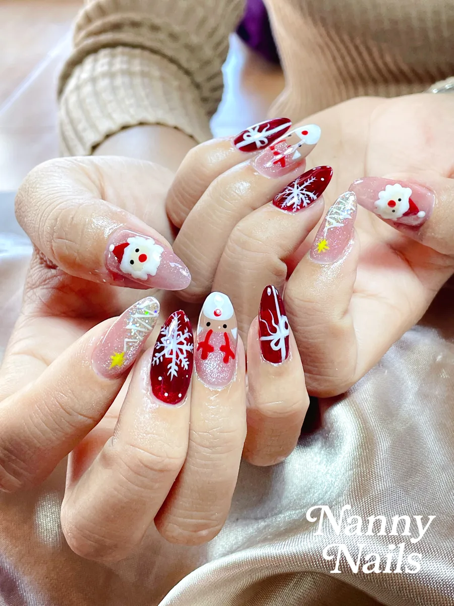 Christmas nail design, red and nude with snowflakes, Santa and reindeer on long almond nails, Nanny Nails, nail salon in Nakhon Phanom