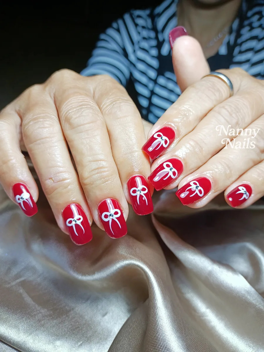 Easy Christmas nails, red gel with white painted bows, Nanny Nails, nail salon in Nakhon Phanom