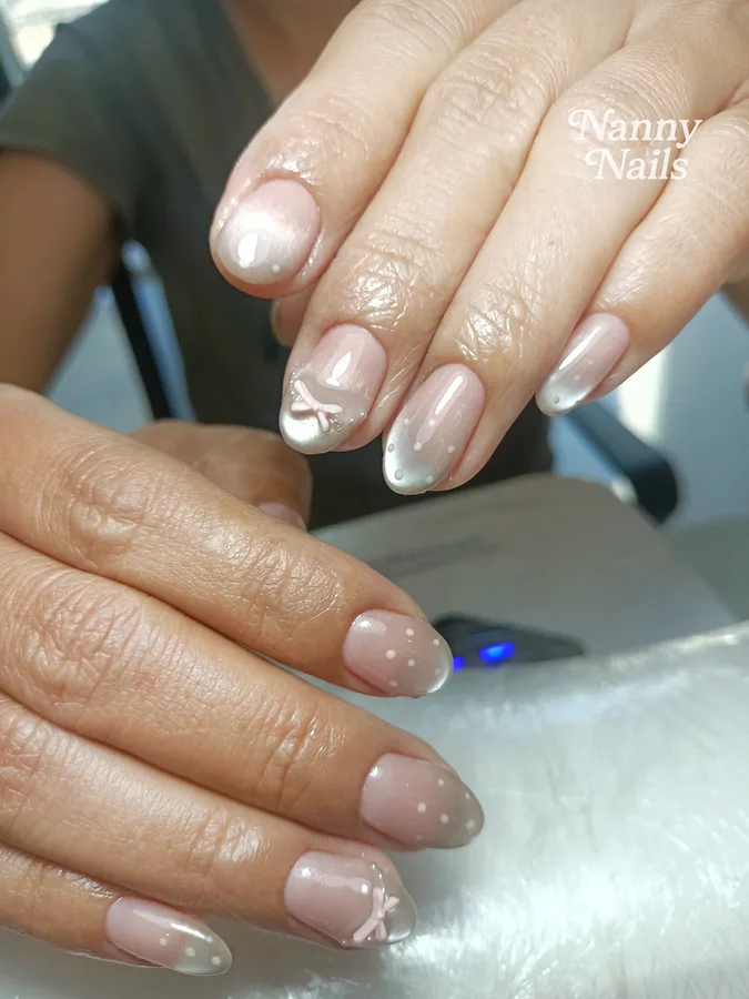 Ombre nails, nude fading to pearly white with painted bows and dots, Nanny Nails, nail salon in Nakhon Phanom
