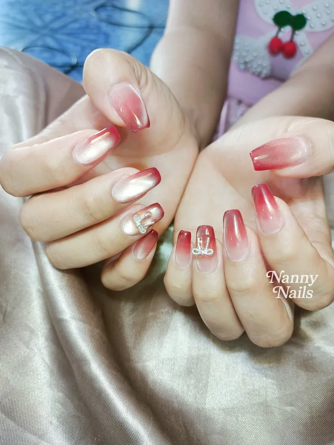 Red ombre nails, nude fading to red with painted bows, Nanny Nails, nail salon in Nakhon Phanom