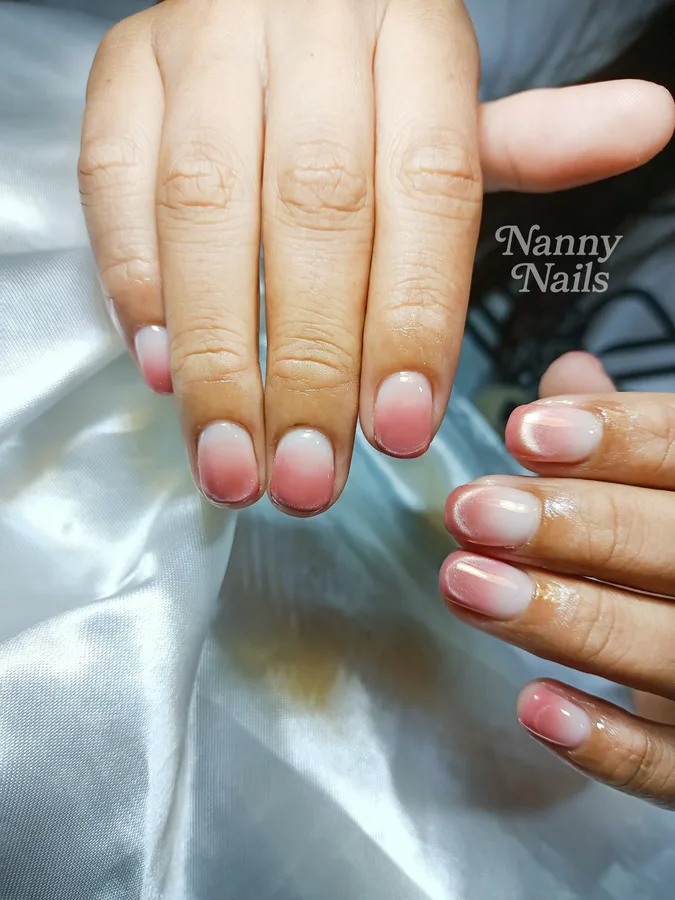 Pink ombre nails, clear fading to pink tips with a cat eye shimmer, Nanny Nails, nail salon in Nakhon Phanom
