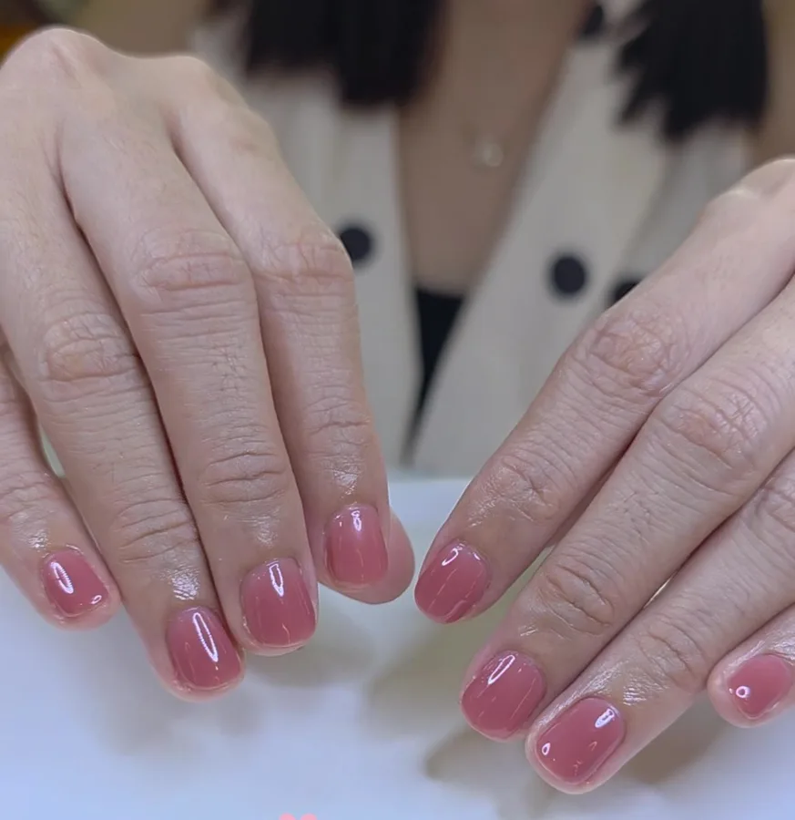 Short nails in a sheer rose nude jelly gel polish, glossy finish, Nanny Nails Nakhon Phanom
