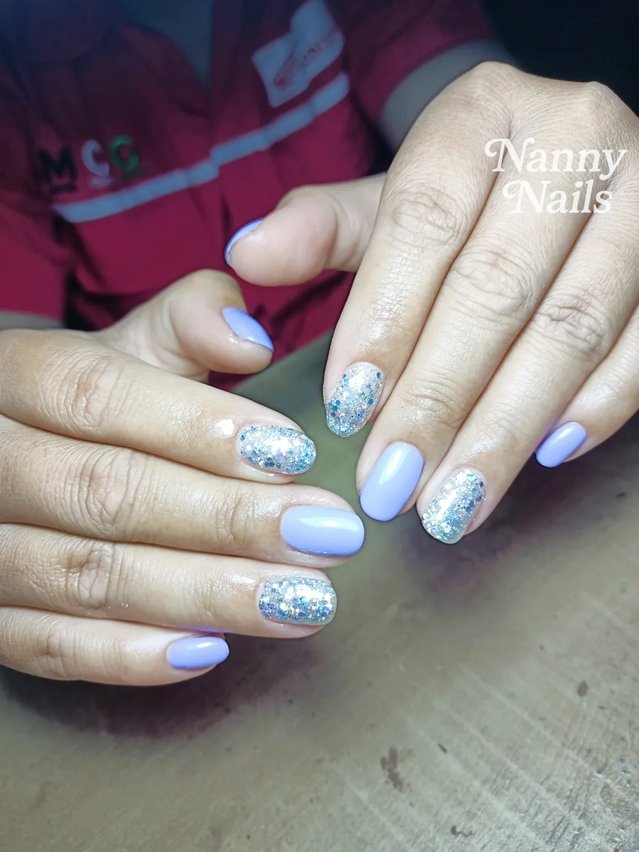 Lavender gel nails with silver glitter accents on fair skin, Nanny Nails, nail salon in Nakhon Phanom