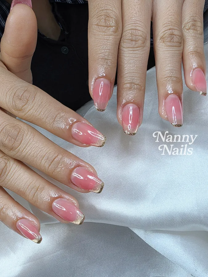 Sheer pink nails with gold French tips for a pink Thai dress, Nanny Nails, nail salon in Nakhon Phanom