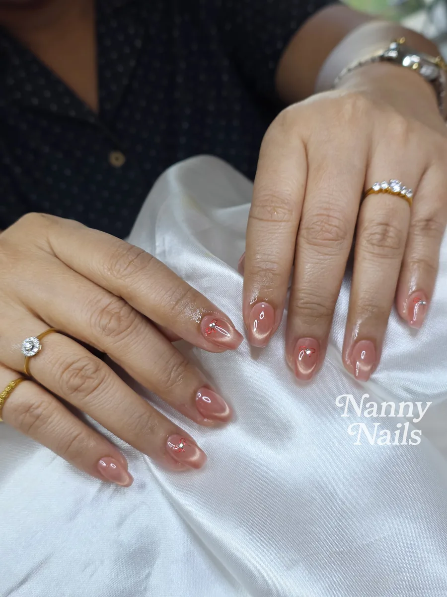 Nude shimmer gel nails in an almond shape, Nanny Nails, nail salon in Nakhon Phanom